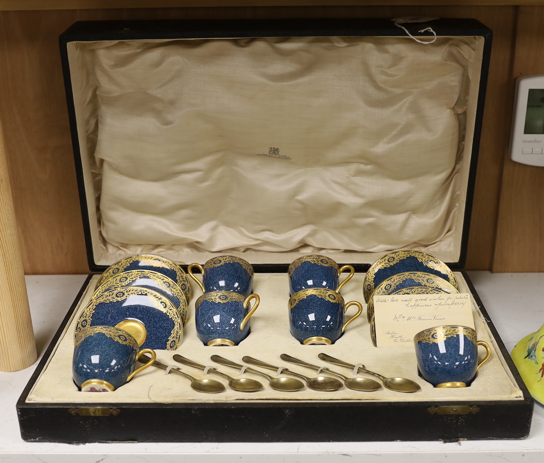 A cased Royal Worcester gilt decorated set of six coffee cans and saucers and six silver coffee spoons, box 10cm high, 41.5cm wide